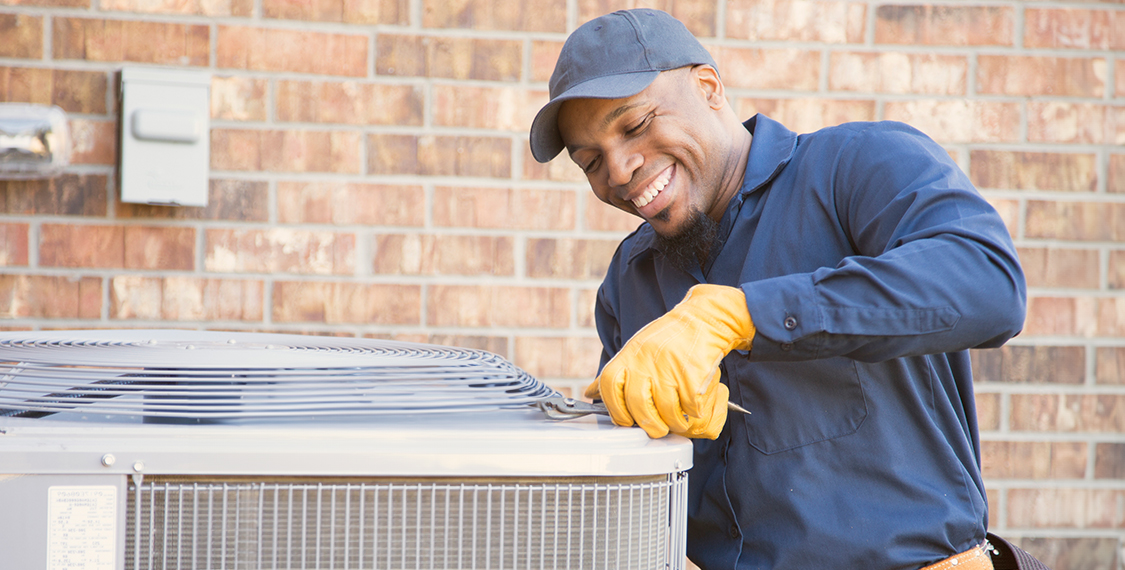 Service technician working on an outdoor unit